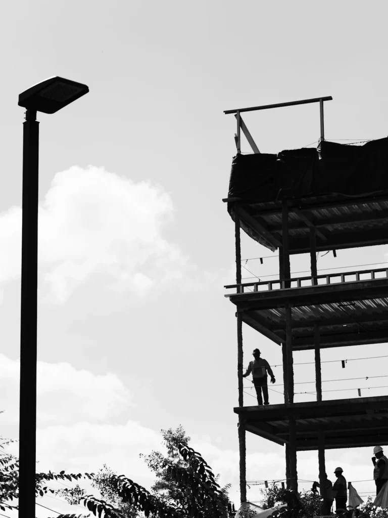 Silhouettes of construction professionals at work on a building site